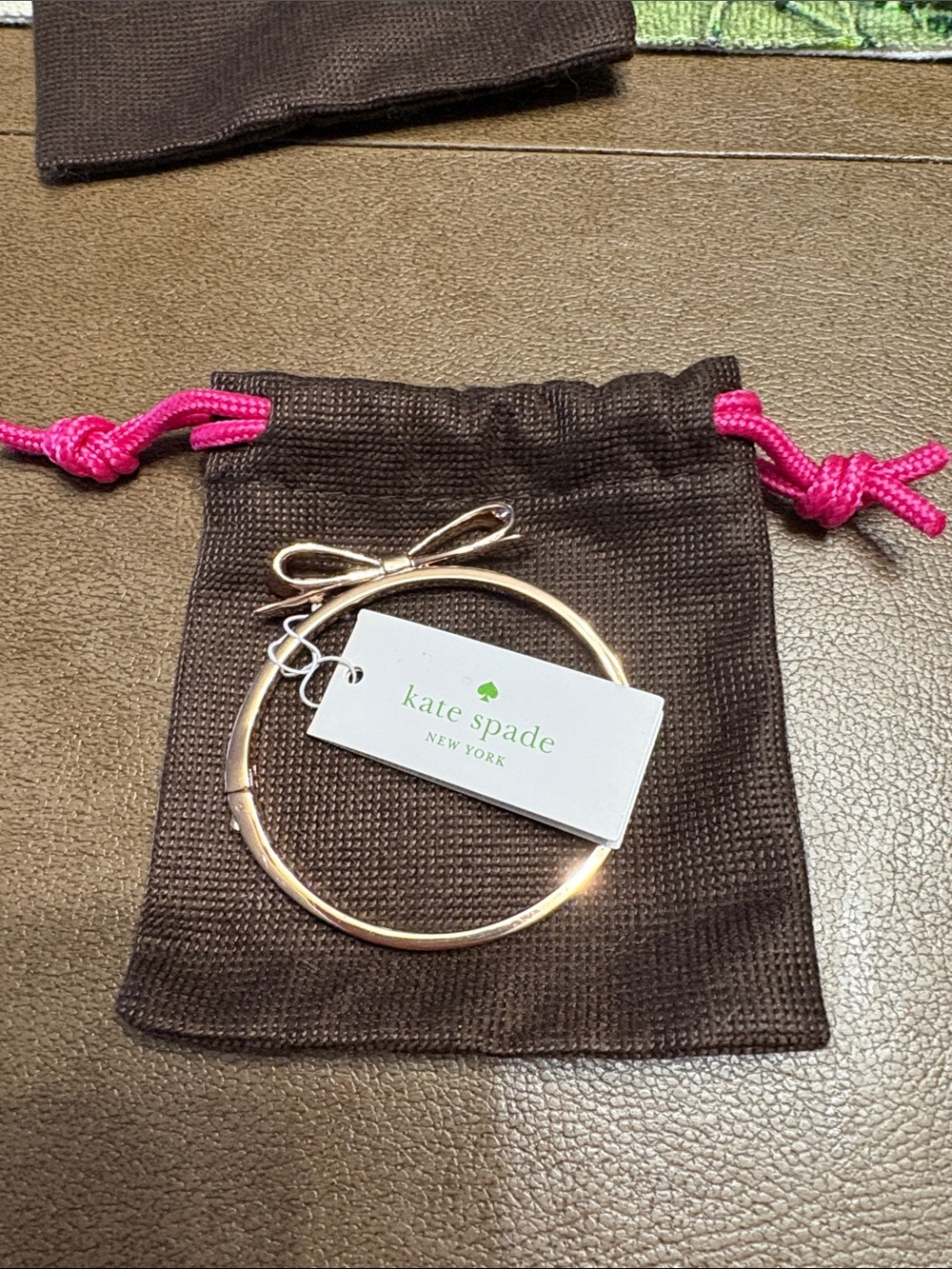 kate spade rose gold bow bangle bracelet with charm tag